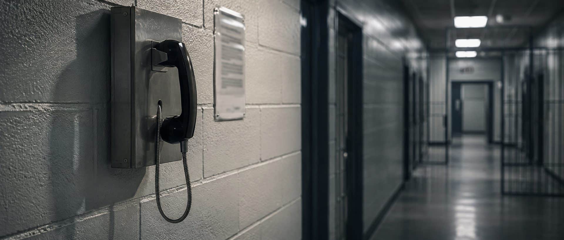 A wall-mounted inmate telephone in a county jail corridor. Calls from a Texas county jail are recorded and reviewed by prosecutors.