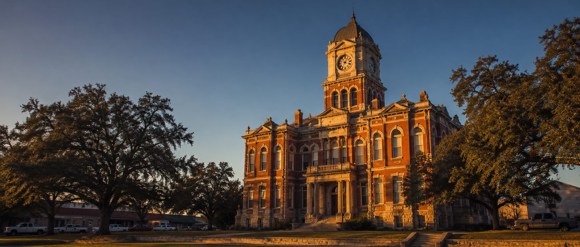 A historic East Texas county courthouse at golden hour, where local jury panels are drawn.